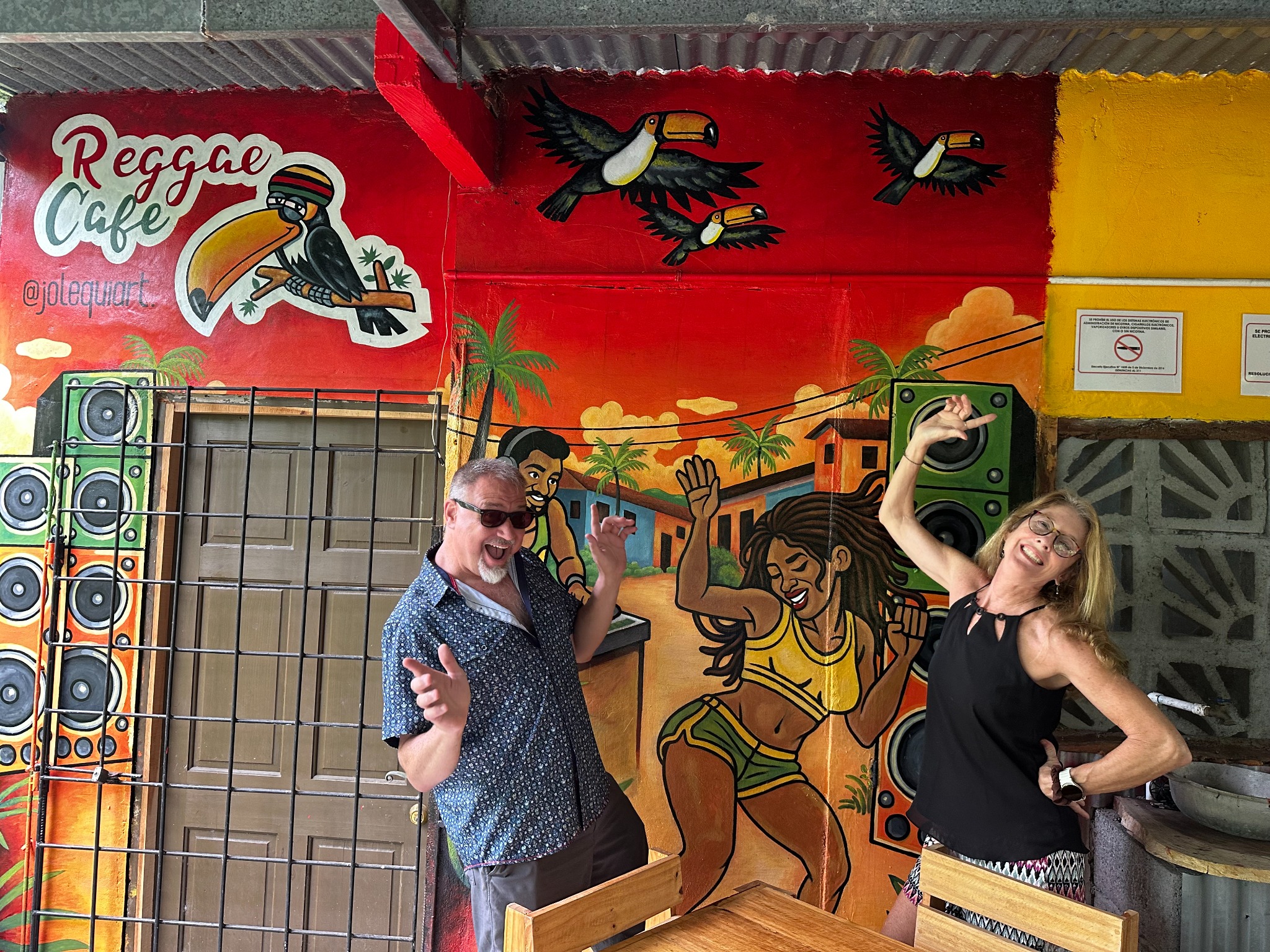 Visitors posing by the Reggae Café mural
